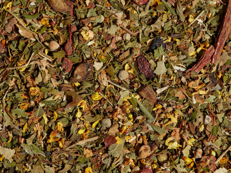 Happy Heart tea loose leaf tea leaves on a flat surface.