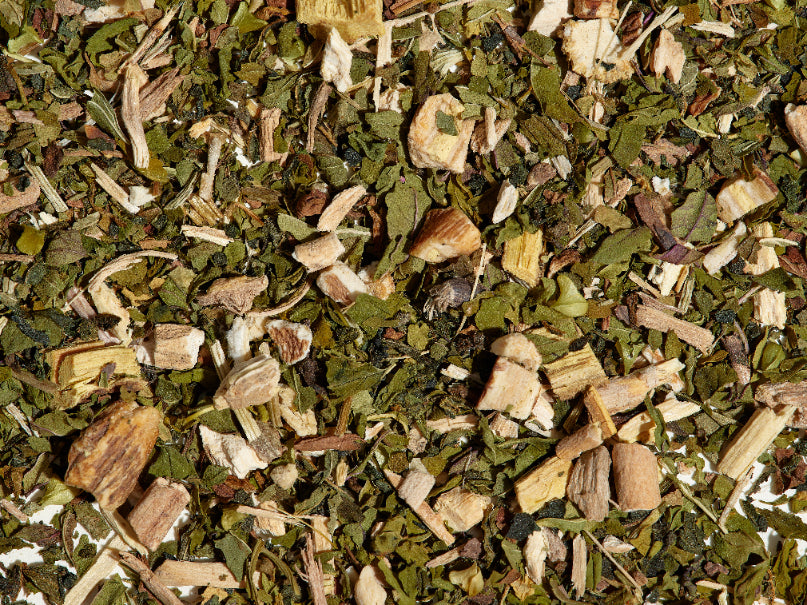 Hercules tea loose leaf tea leaves on a flat surface.