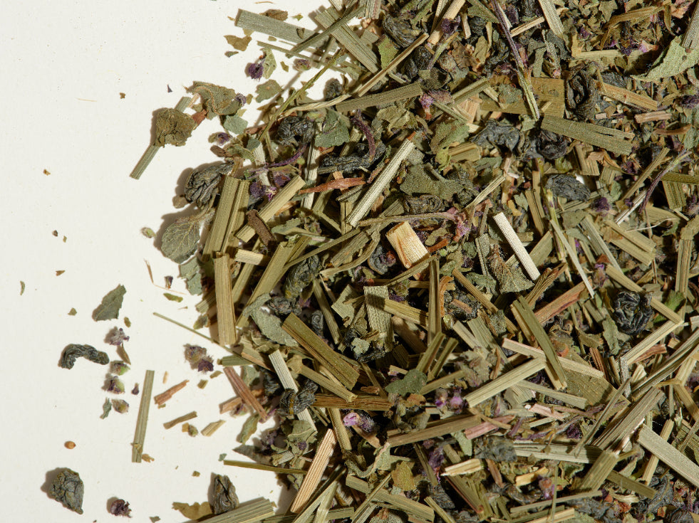 Think tea loose leaf tea leaves on a flat surface.