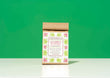 A kraft paper bag of Harbor Herbalist Allergy Support Loose Leaf Tea, featuring a white label with pink and green botanical illustrations, set against a solid green background.