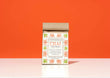 A kraft paper bag of Harbor Herbalist Chai Spicy Masala tea stands upright on a white surface against a solid orange background. The packaging features a white front label with orange and green botanical illustrations.