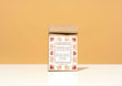 A kraft paper bag for Harbor Herbalist Chocolat, featuring a white label decorated with red and orange botanical illustrations, standing upright on a white surface against a warm beige background.